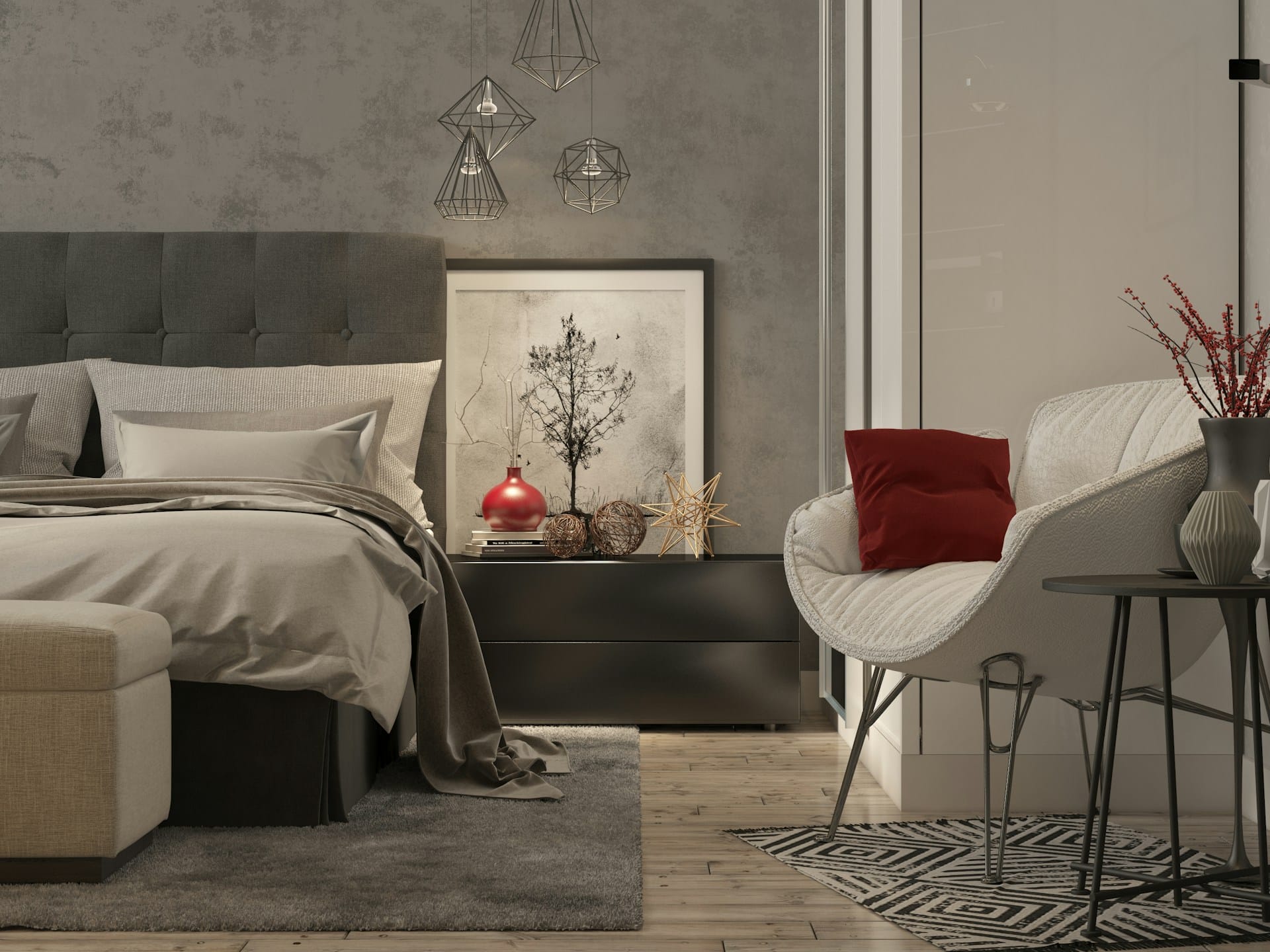 Cozy modern bedroom with a grey upholstered bed, neutral bedding, geometric pendant lights, abstract wall art, and a white accent chair with a red pillow beside a black side table on a patterned rug